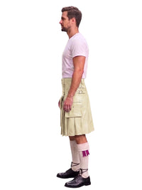 A man shown in profile wearing a light beige kilt with a white t-shirt, white socks, and black shoes, photographed against a solid white background.