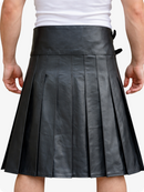 Black pleated leather skirt worn by a person on a white background