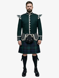 Man wearing a traditional Scottish black watch tartan kilt with a dark green doublet jacket on a white background