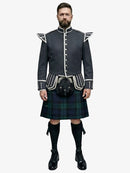 Man wearing a traditional Scottish black watch tartan kilt with a dark grey jacket on a white background