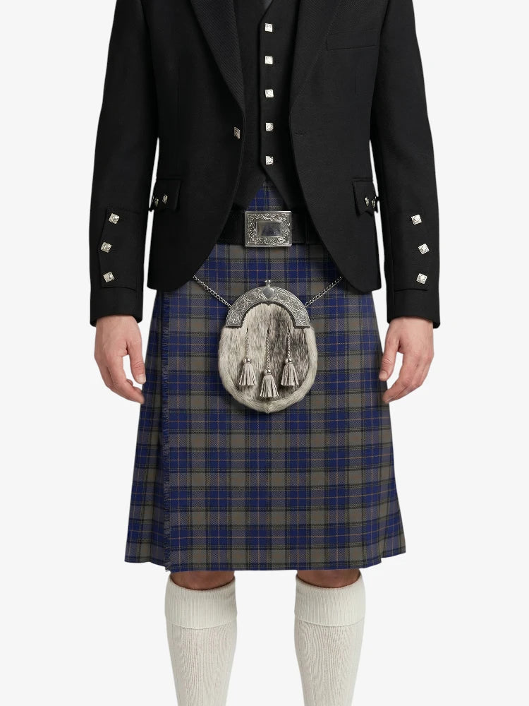 Person wearing a traditional Scottish kilt with a jacket on a white background