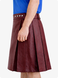 Burgundy leather skirt worn by a person on a white background