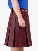 Burgundy pleated skirt worn by a person on a white background