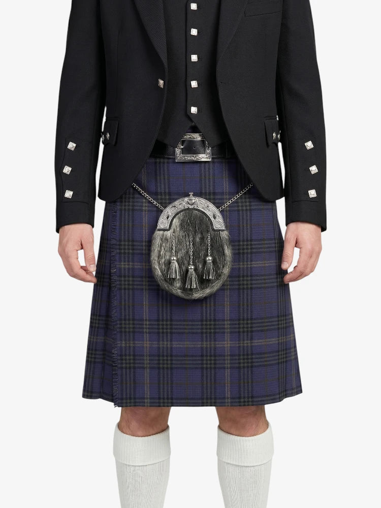 Person wearing a black jacket with white buttons, a blue plaid kilt, and white knee-high socks on a white background.