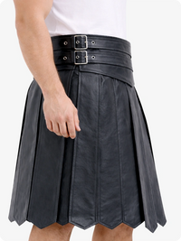 Charcoal leather skirt with silver buckles worn by a person on a white background