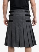 Person wearing a Charcoal pleated kilt with black belts on a white background