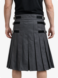 Person wearing a Charcoal pleated kilt with black belts on a white background