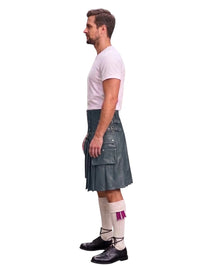 A man shown in profile wearing a dark gray leather kilt, a light pink t-shirt, white socks with a purple bow, and black shoes, set against a plain white background.