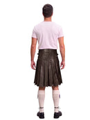 A man shown from the back wearing a dark brown leather kilt, a light pink t-shirt, cream-colored knee-high socks, and black shoes, isolated on a white background.