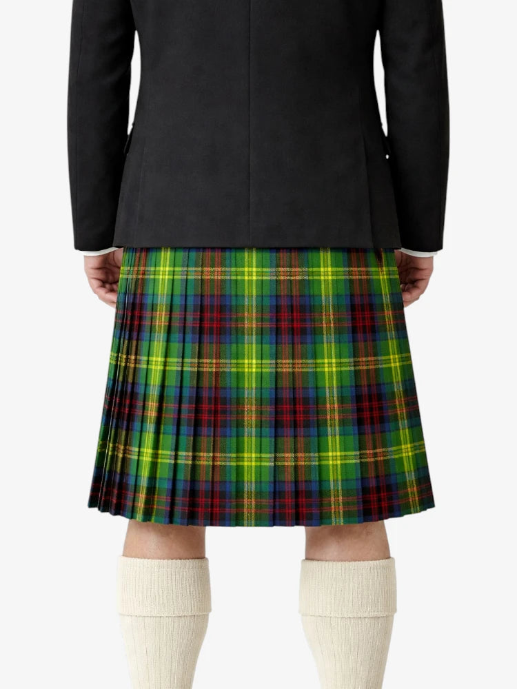 Person wearing a black jacket and a colorful plaid kilt on a white background