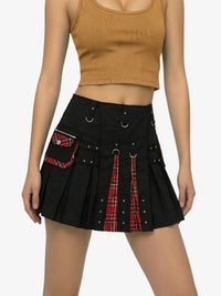 Black skirt with red plaid accents worn by a person on a white background