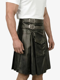 Person wearing a black leather kilt with silver buckles on a white background