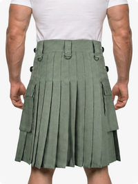 Person wearing a green pleated kilt on a white background