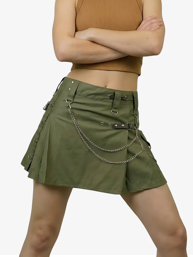 Green skirt with chain details worn by a person on a white background