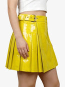 Yellow pleated skirt worn by a person on a white background