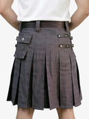 Person wearing a gray pleated kilt with leather accents on a white background