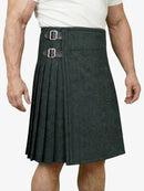 Person wearing a gray pleated kilt on a white background