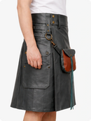 Person wearing a black leather kilt with brown leather pouches on a white background