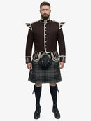 Man wearing a traditional Scottish grey watch tartan kilt with a dark brown jacket on a white background