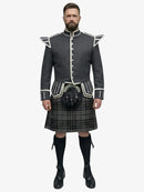 Man wearing a traditional Scottish grey watch tartan kilt with a grey jacket on a white background