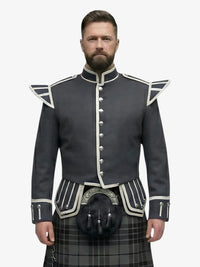 Man wearing a dark gray jacket with white trim and a grey watch tartan kilt on a white background
