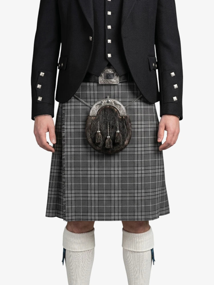 Person wearing a traditional Scottish kilt with a sporran on a white background