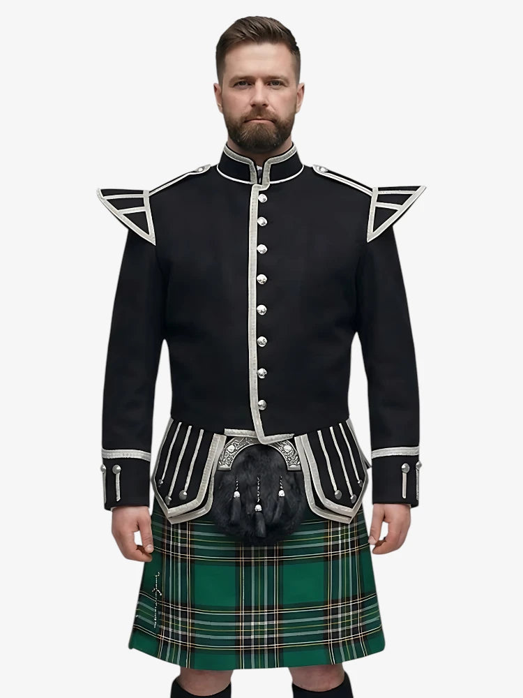 Man wearing a black doublet jacket with white trim and a irish national plaid tartan kilt on a white background