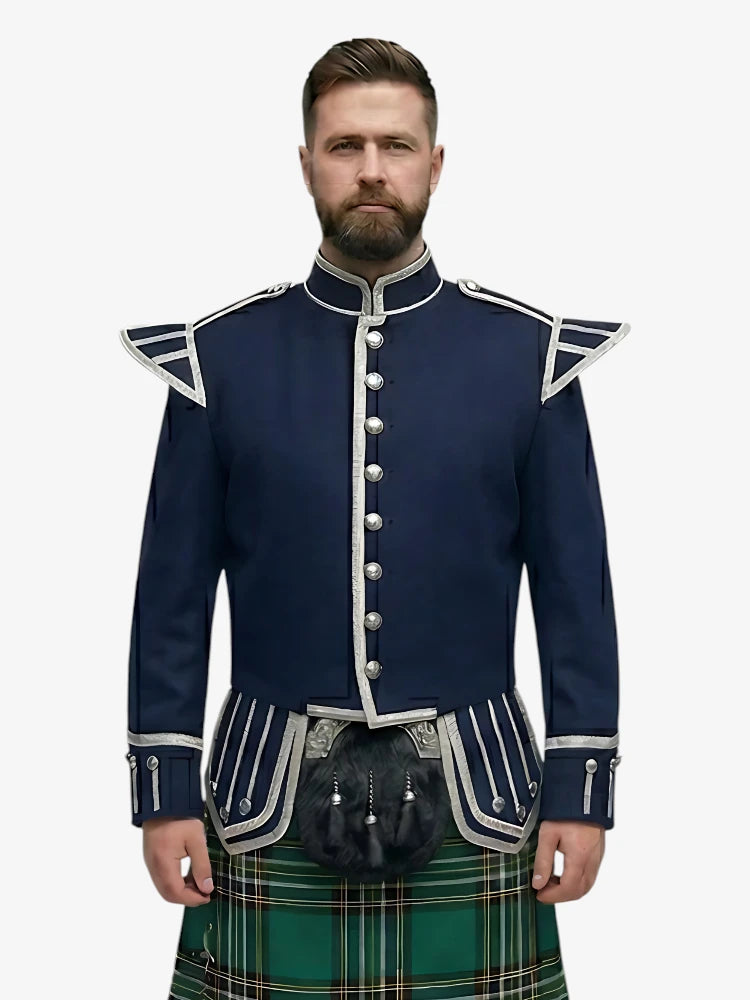 Man wearing a navy blue jacket with white trim and a irish national tartan kilt on a white background