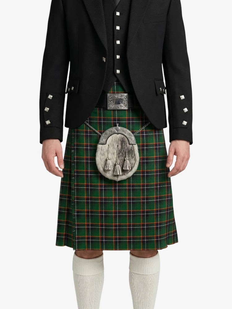 Person wearing a traditional Scottish kilt with a black jacket and white socks on a white background