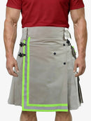 Person wearing a gray kilt with green accents on a white background