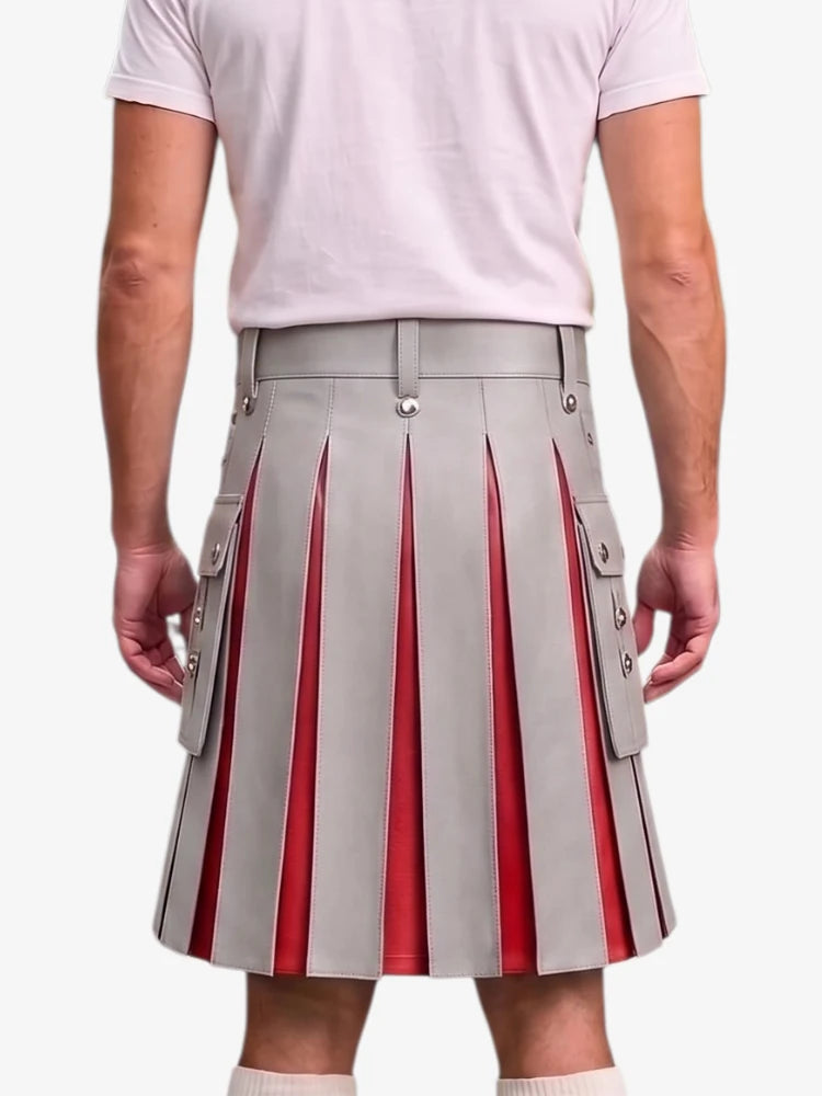 A person shown from the back wearing a light gray pleated kilt with vertical red pleated inserts and side flap pockets with metal snap details, paired with a pale pink T-shirt and white socks against a light gray studio background.