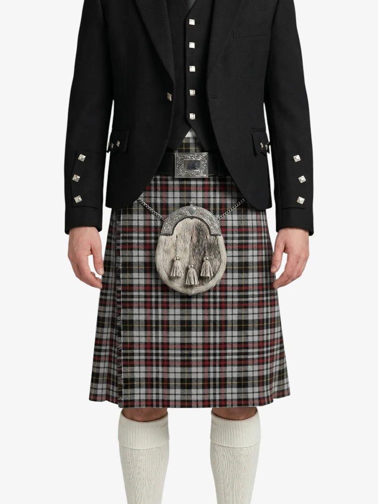 Person wearing a traditional Scottish kilt with a black jacket on a white background