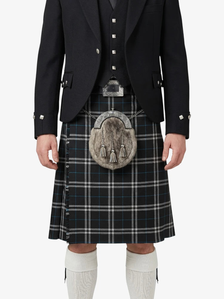 Person wearing a traditional Scottish kilt with a jacket on a white background