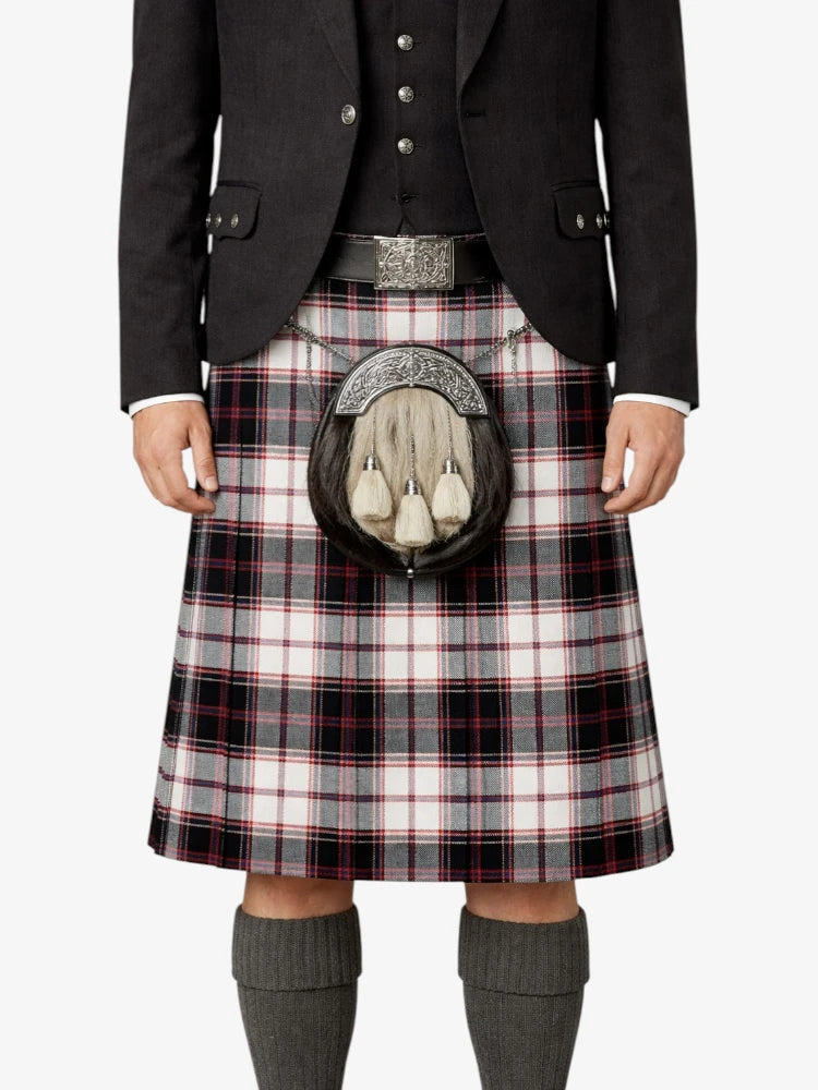 Person wearing a Scottish kilt with a sporran on a white background