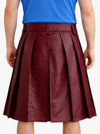 Maroon pleated skirt worn by a person with a blue top on a white background