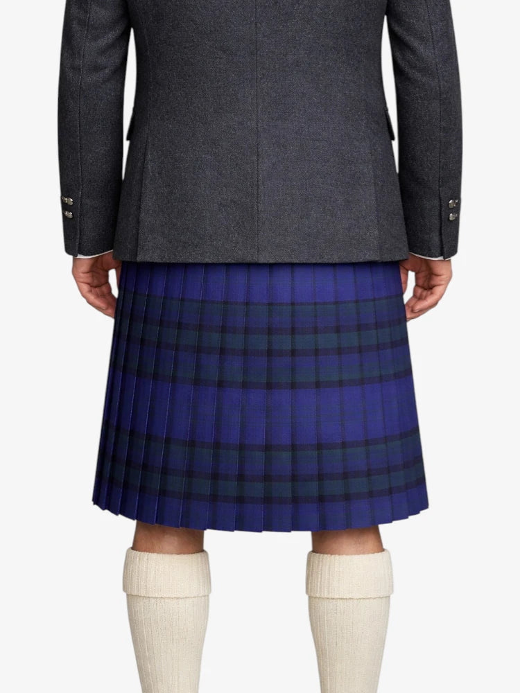 Person wearing a gray coat and blue plaid kilt on a white background
