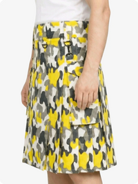 Skirt with yellow and gray pattern worn by a person on a white background