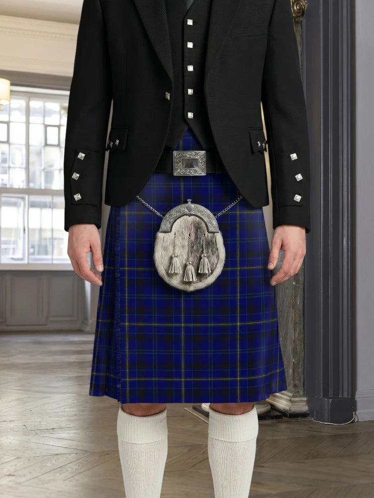 Person wearing a blue plaid kilt with a black jacket and white knee-high socks indoors.