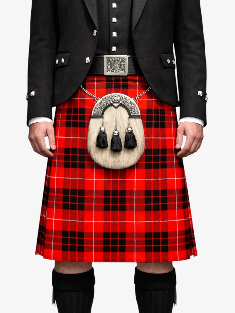 Person wearing a red tartan kilt with a black jacket on a white background