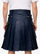 Person wearing a navy pleated Leather Kilt with gold buttons on a white background