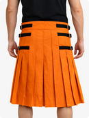 Orange pleated skirt with black straps worn by a person on a white background
