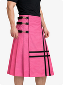 Person wearing a pink skirt with black straps and accents on a white background