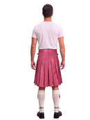 A man shown from the back wearing a pink pleated kilt, a light pink t-shirt, cream-colored knee-high socks, and black shoes, set against a plain white background.