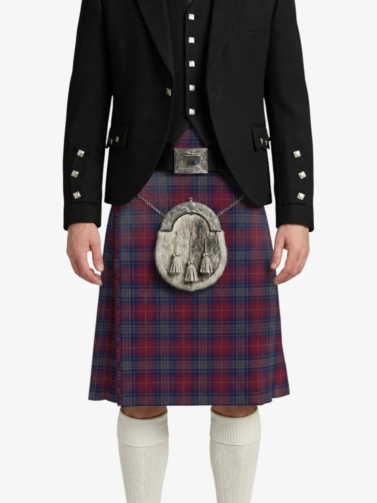 Person wearing a traditional Scottish kilt with a jacket on a white background