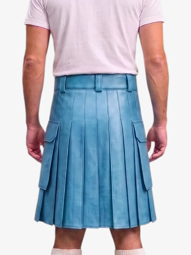 A person shown from the back wearing a light blue pleated leather kilt with side cargo pockets, paired with a pale pink t-shirt and white socks, against a light gray studio background.