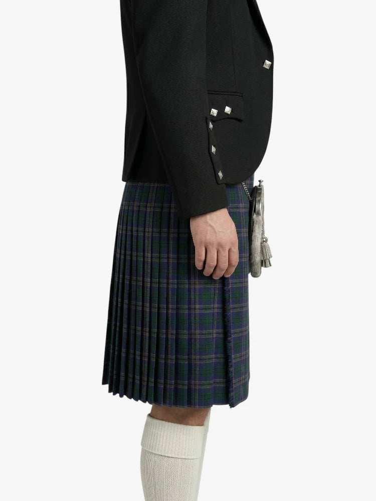 Person wearing a black blazer and plaid kilt on a white background