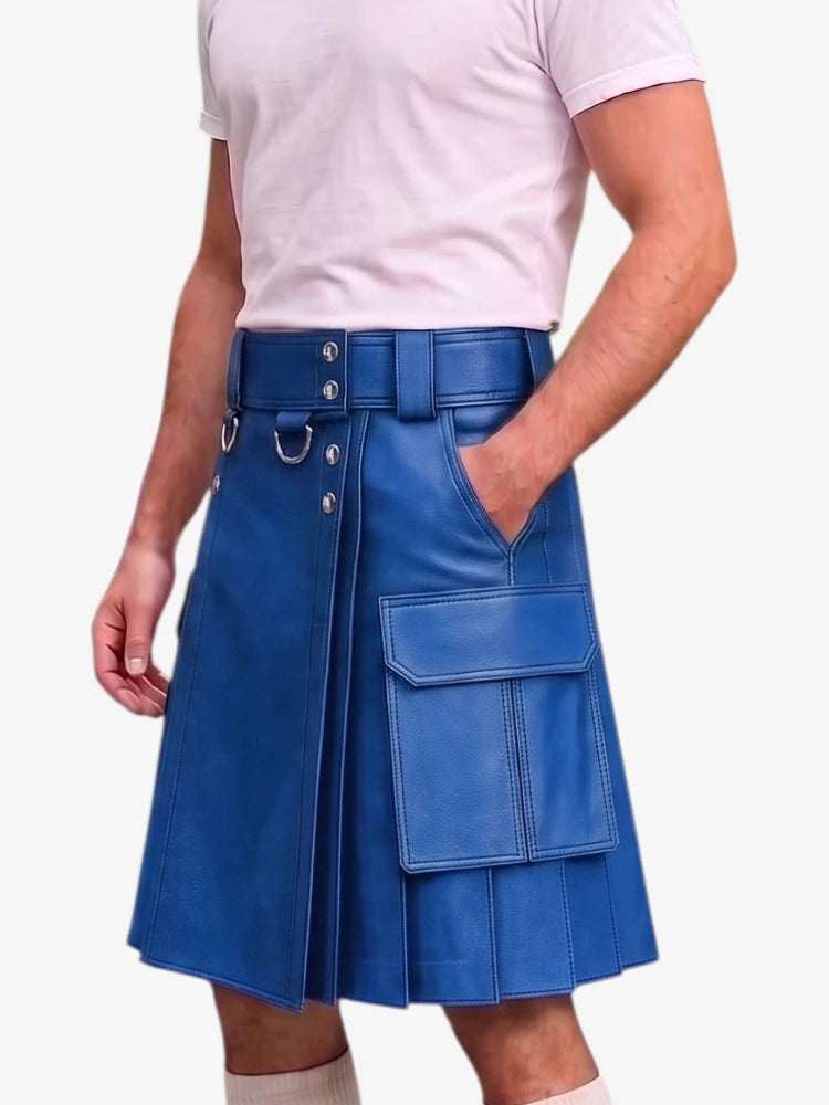 A man wearing a bright blue faux-leather kilt with a matching belt, silver-tone hardware, and large cargo pockets, paired with a light pink t-shirt against a plain white background.