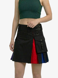 Person wearing a black skirt with red and blue accents on a white background