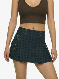 Person wearing a green plaid skirt and brown crop top on a white background